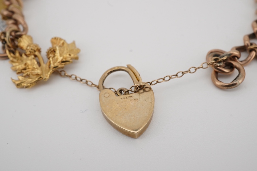 A 9ct gold charm bracelet, with heart shaped clasp, hung with fourteen assorted charms including five 9ct, two 14k and two 18k and five unmarked, gross weight 39 grams. Condition - fair